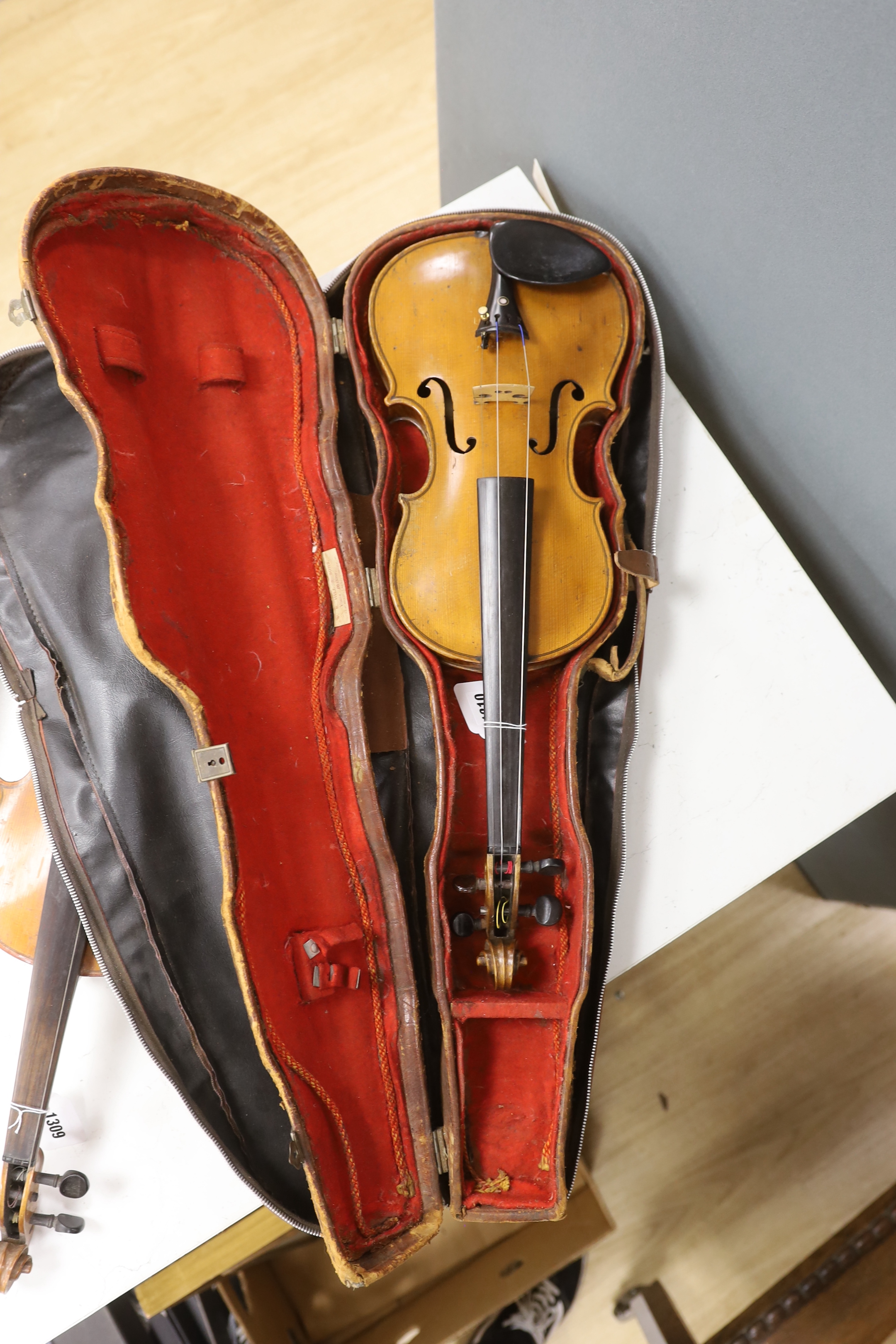 A cased early twentieth century violin by Rudolph Raymond, with maker’s label inside the body stating ‘made 1904’, body 36cm, in a good case with a label for W.E. Hills & Sons, Violin Makers, 140 New Bond St. London